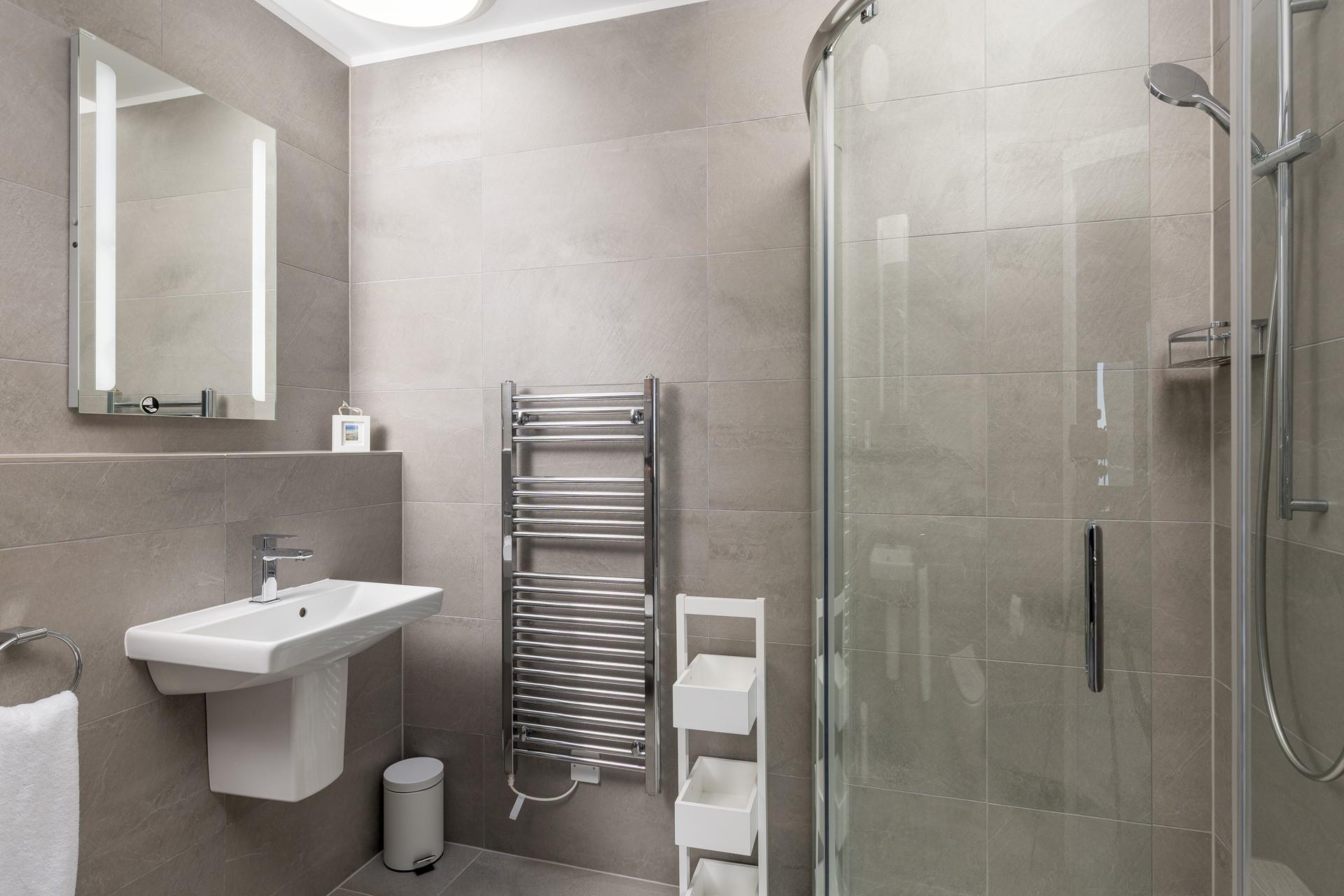 The modern en suite shower room is perfect for a post-swim rinse!