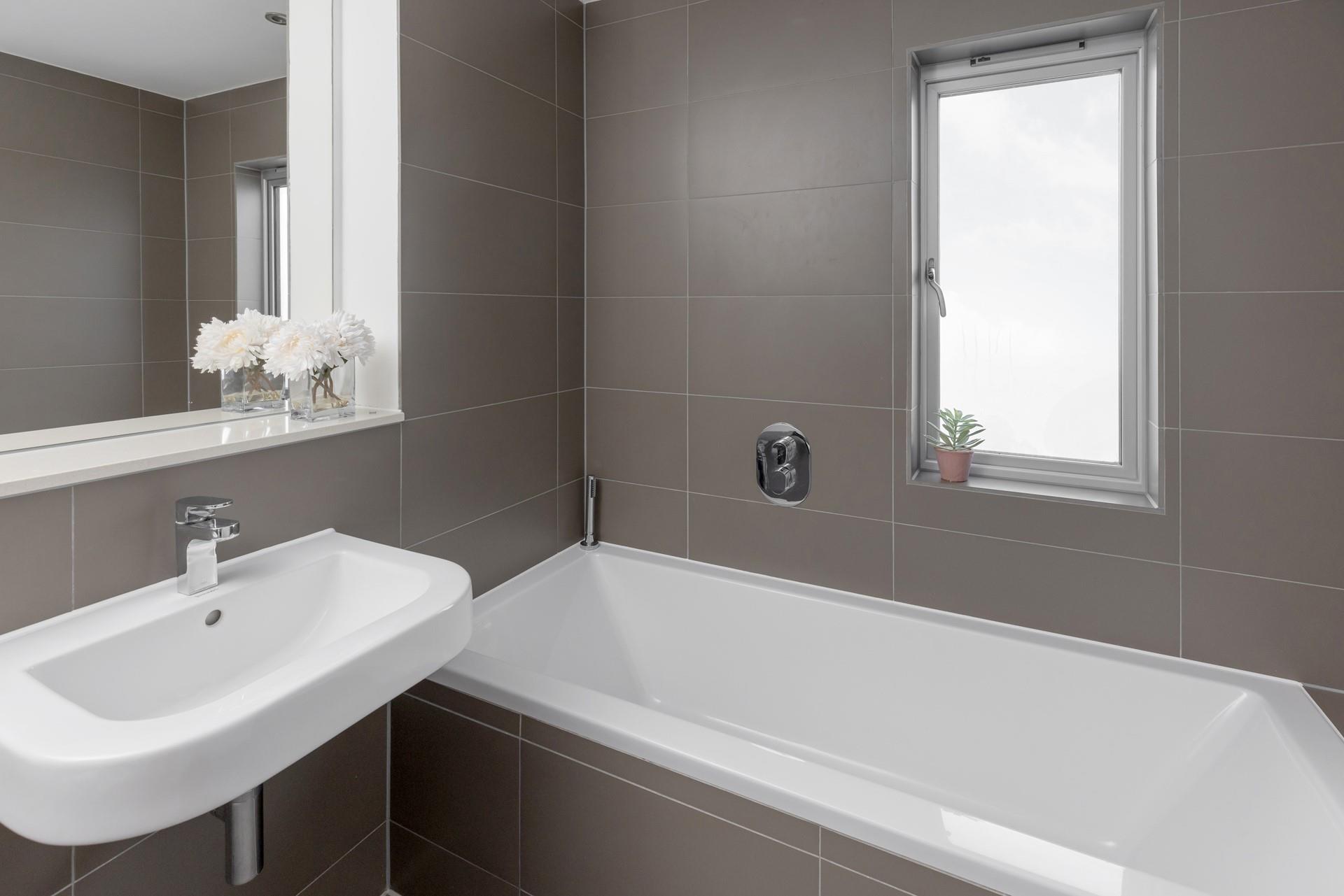 Enjoy a rejuvenating soak in the tub after busy beach days. 