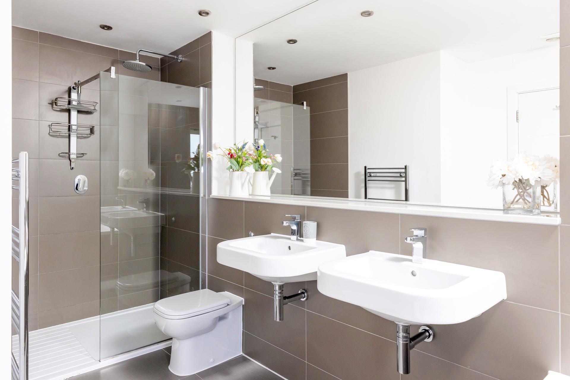 The family bathroom has a spacious shower and dual sinks.