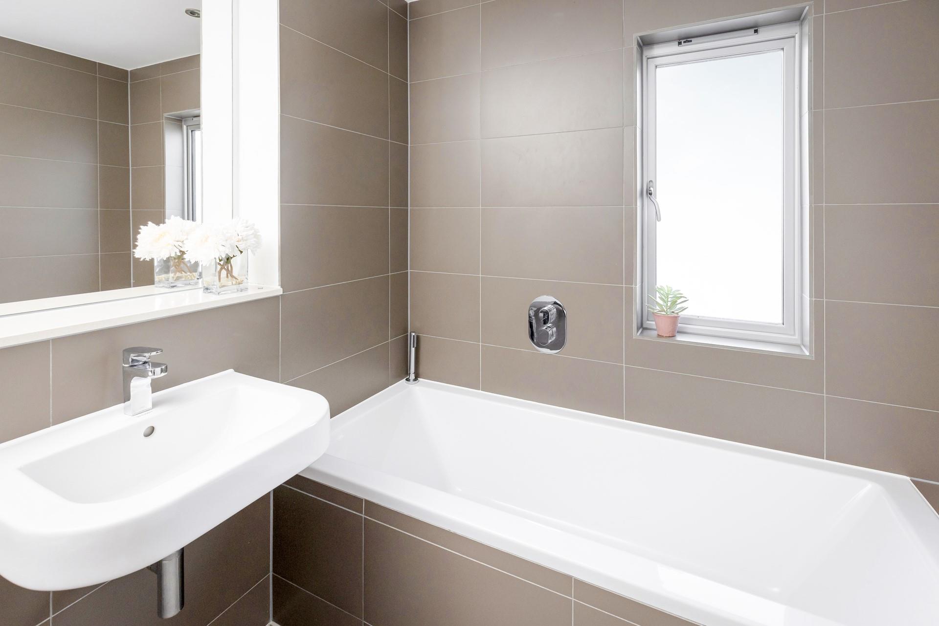 The chic en suite is perfect for a soak after a day on the beach!
