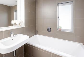 The chic en suite is perfect for a soak after a day on the beach!