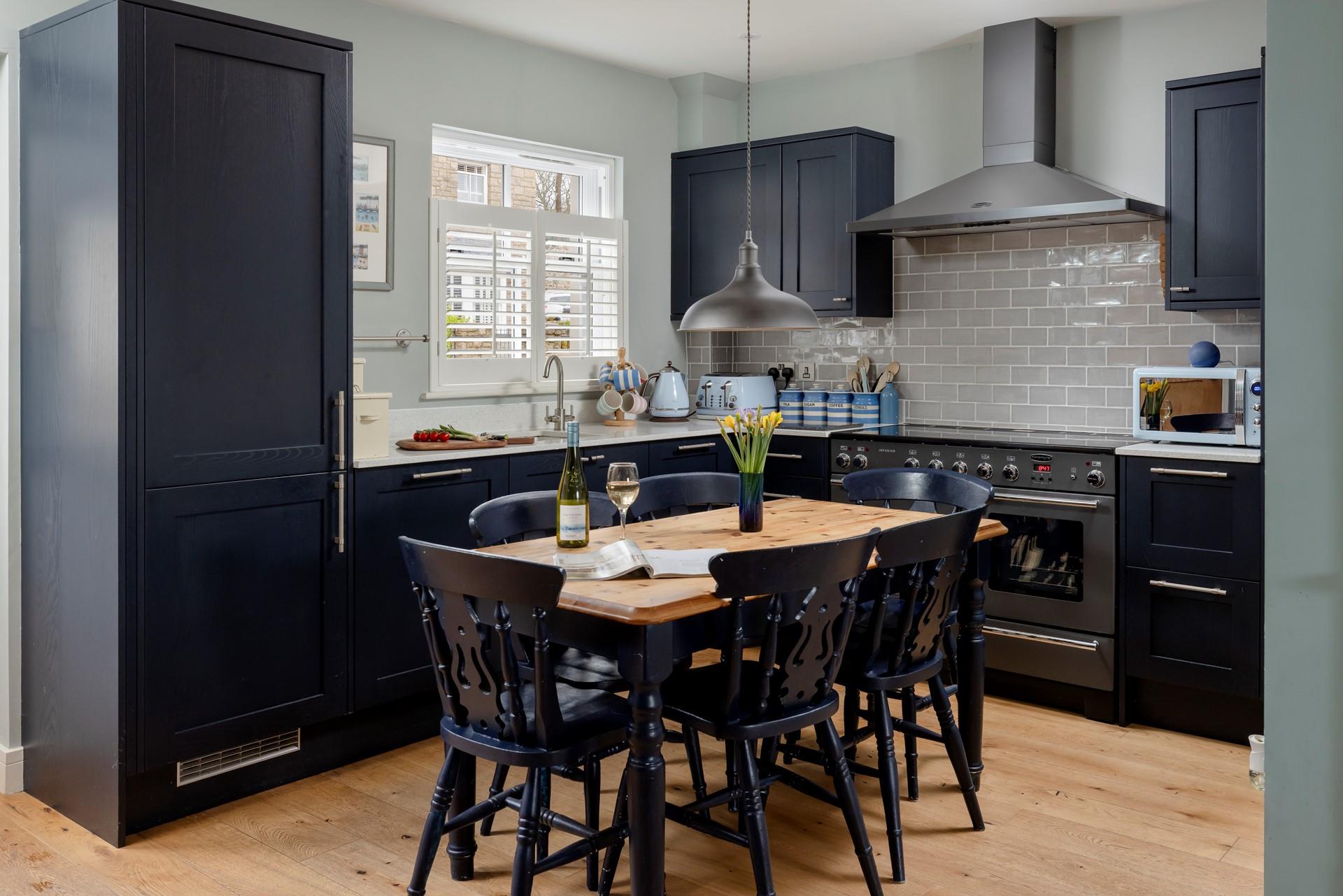 The kitchen is modern and stylish for preparing and cooking meals.