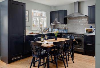 The kitchen is modern and stylish for preparing and cooking meals.