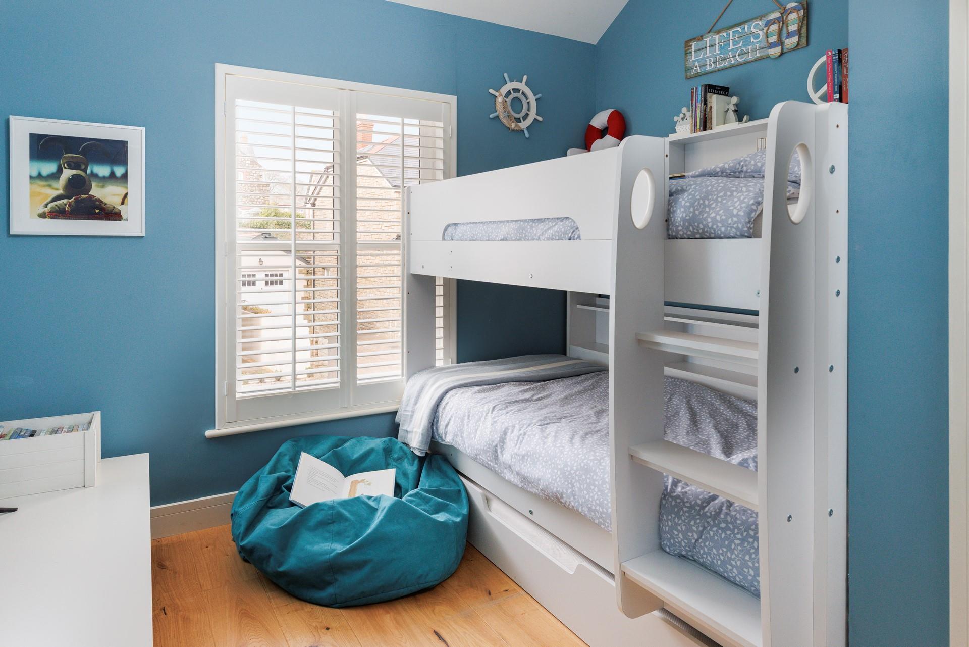 The bunk bed room has a fun nautical design!