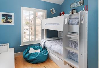 The bunk bed room has a fun nautical design!