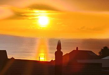 Watch the sun set over the ocean after a day of adventures. 