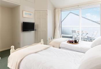 Enjoy slow mornings in this light and calming bedroom.