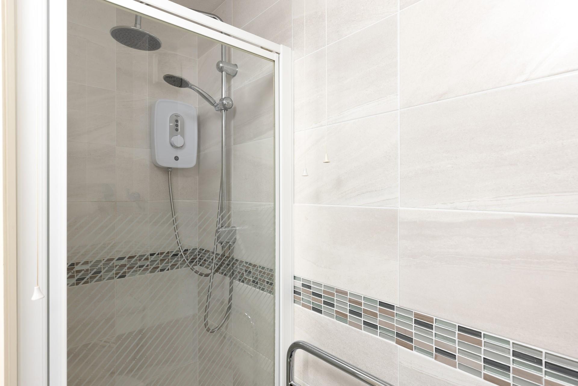 The en suite has a walk-in rainfall shower.