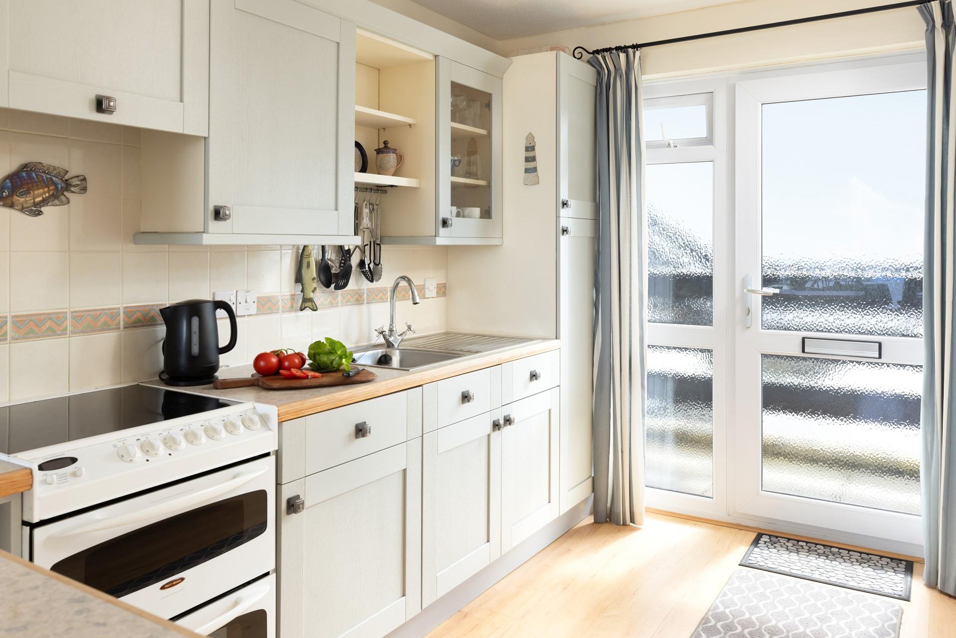 Light and well-equipped, the kitchen has a lovely cottage-like feel.