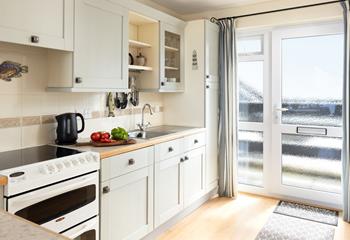 Light and well-equipped, the kitchen has a lovely cottage-like feel.