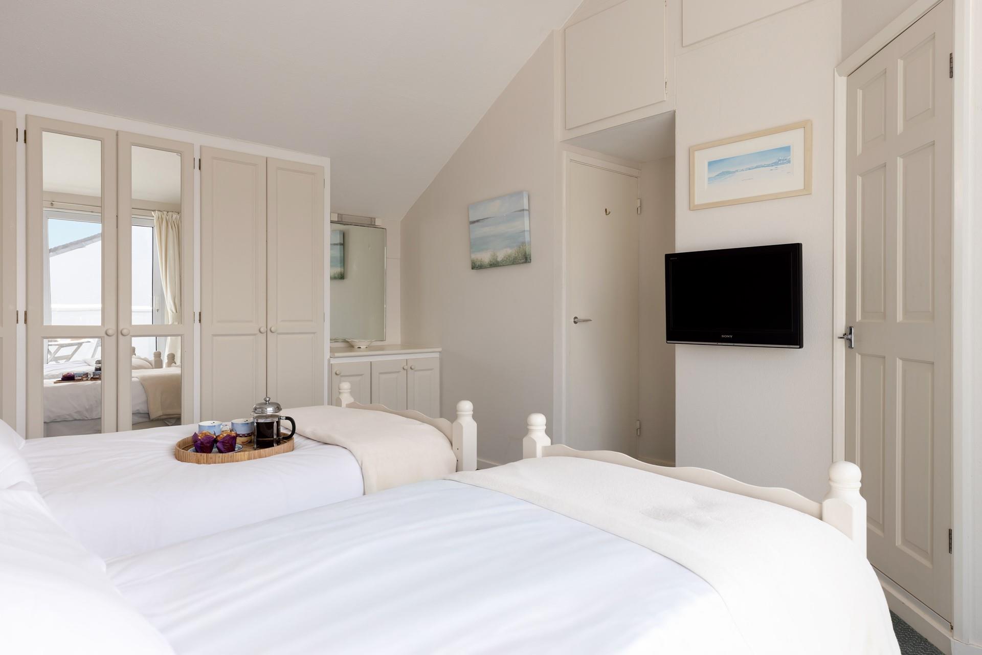 Coastal decor adorns the bedroom, reflecting the seaside location.