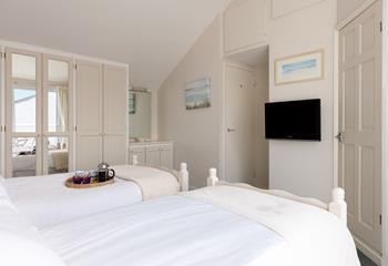 Coastal decor adorns the bedroom, reflecting the seaside location.