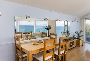 Enjoy a delicious meal over the reflection of the ocean.