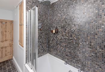 The stylish bedroom boasts a rainfall shower and bath.