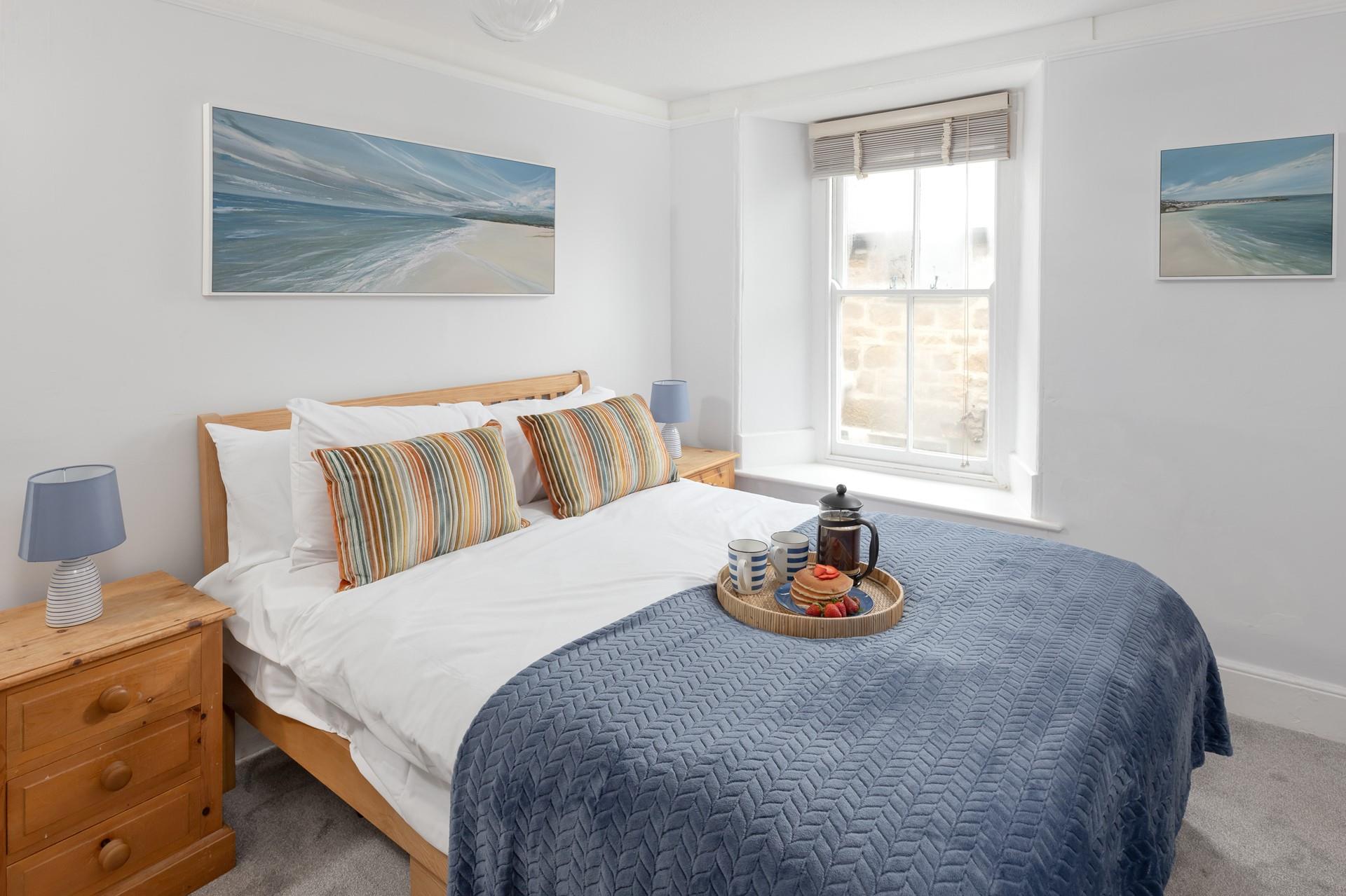 Bedroom 1 is decorated with calming coastal blues.