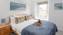 Bedroom 1 is decorated with calming coastal blues.