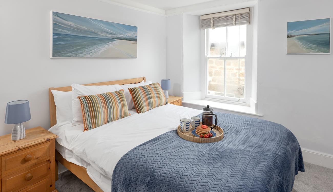 Bedroom 1 is decorated with calming coastal blues.
