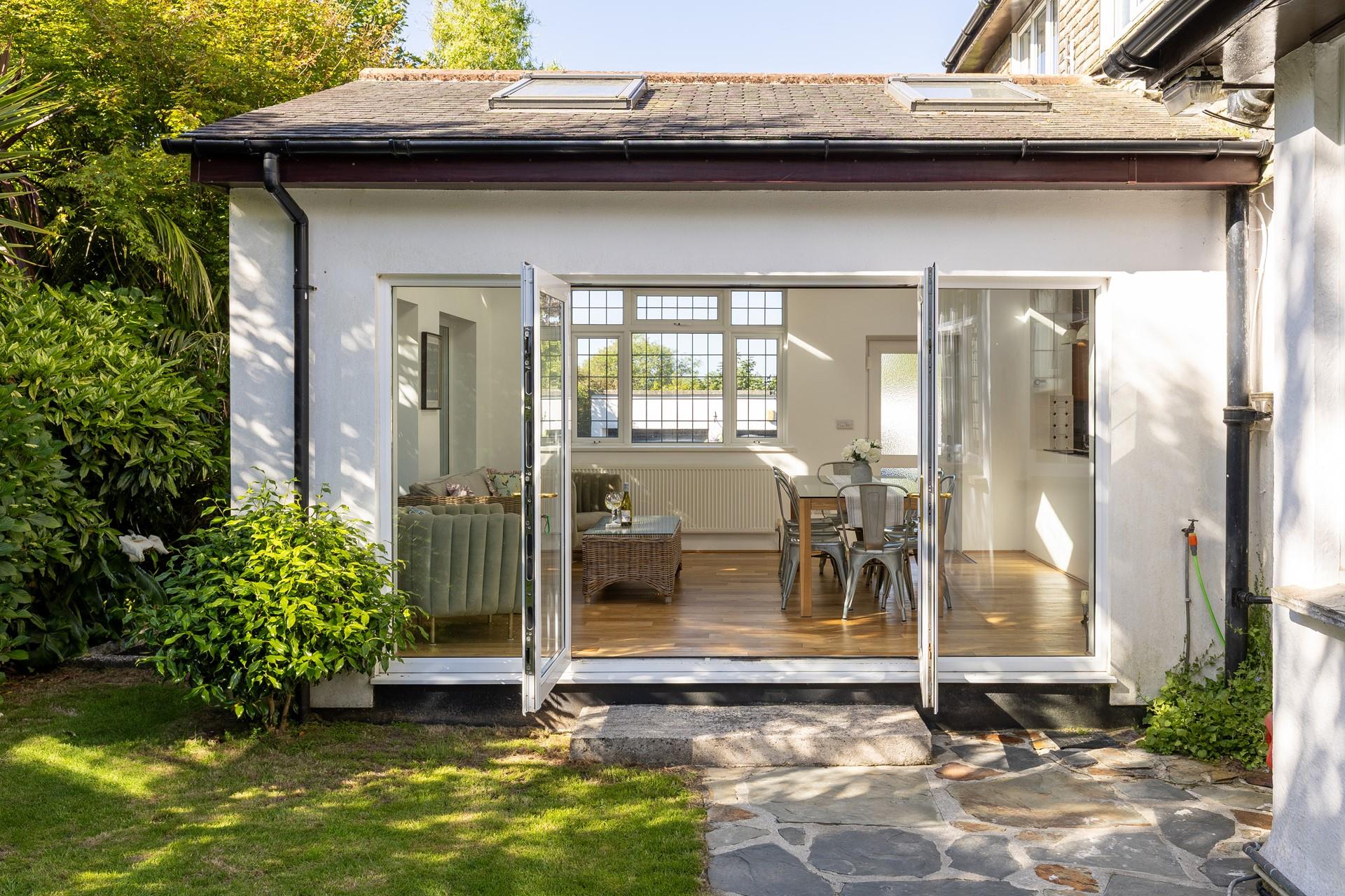 The light and airy dining room is nestled within the pretty gardens.