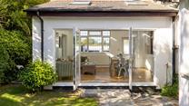 The light and airy dining room is nestled within the pretty gardens.