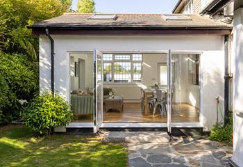 The light and airy dining room is nestled within the pretty gardens.