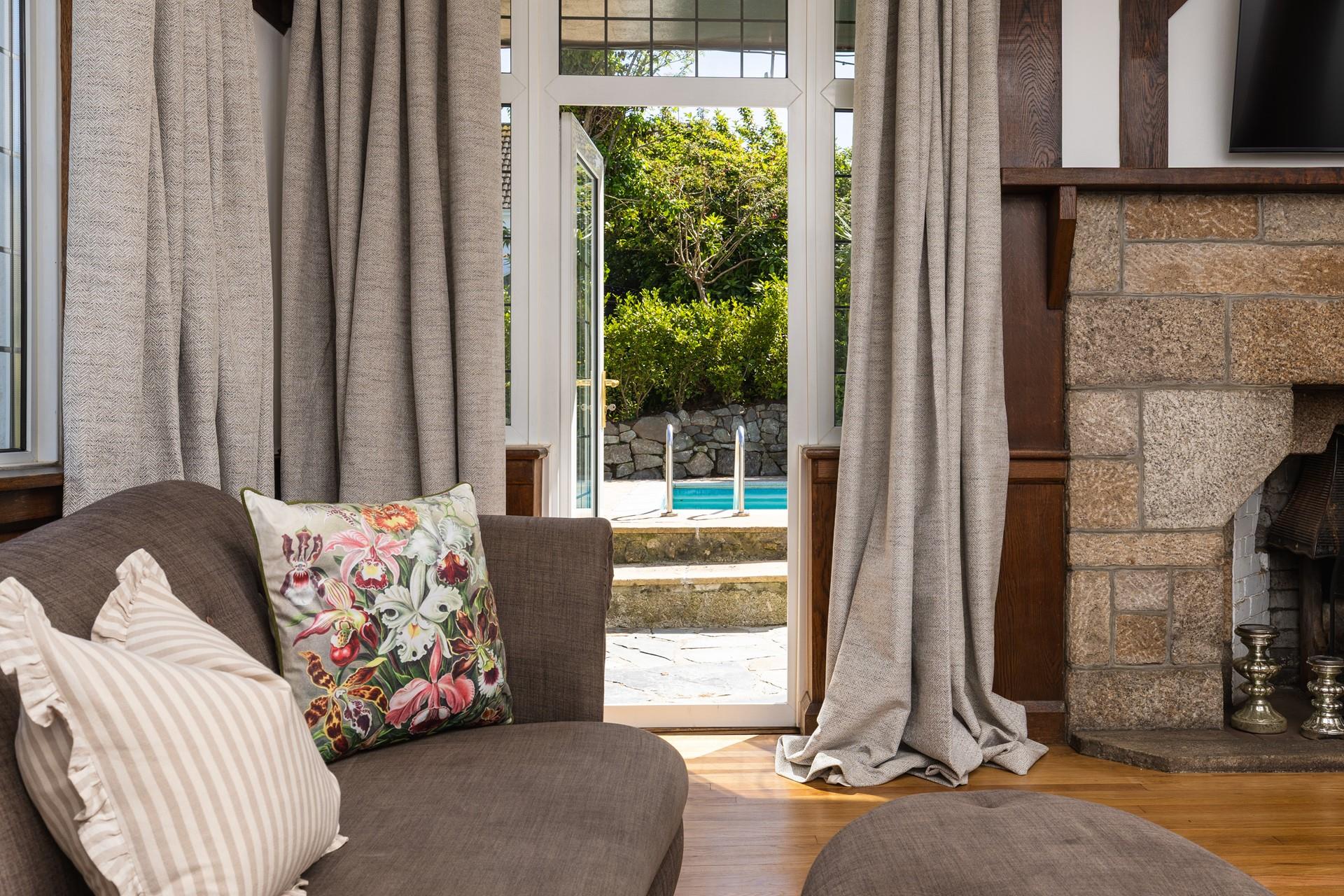 The sitting room has direct garden access, from the sofa to the pool in seconds!