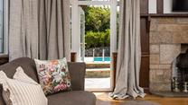 The sitting room has direct garden access, from the sofa to the pool in seconds!