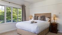 Light and airy bedroom 2 blends natural textures with classic features.
