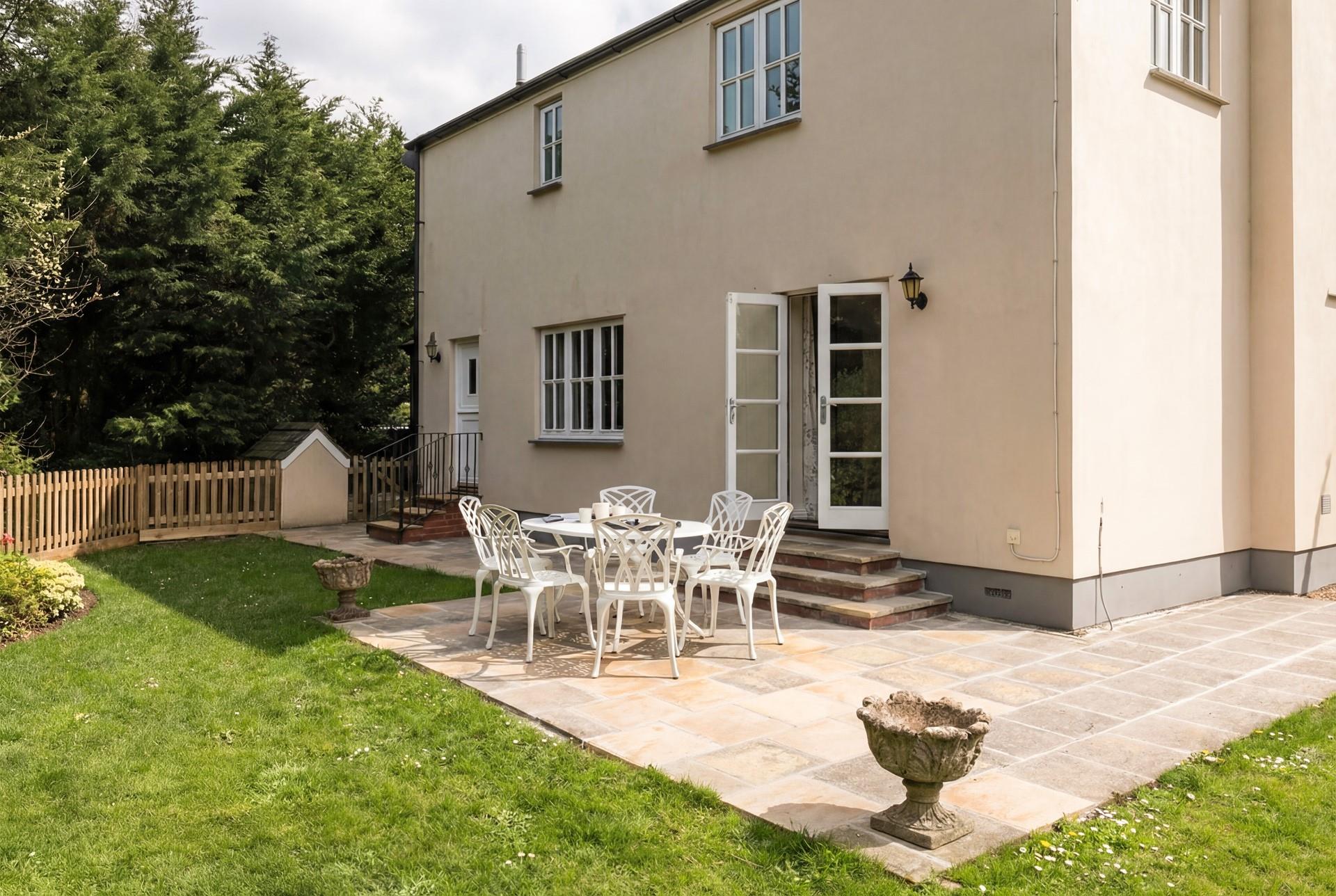 The enclosed garden is bursting with colourful flora.