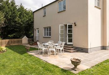 The enclosed garden is bursting with colourful flora.