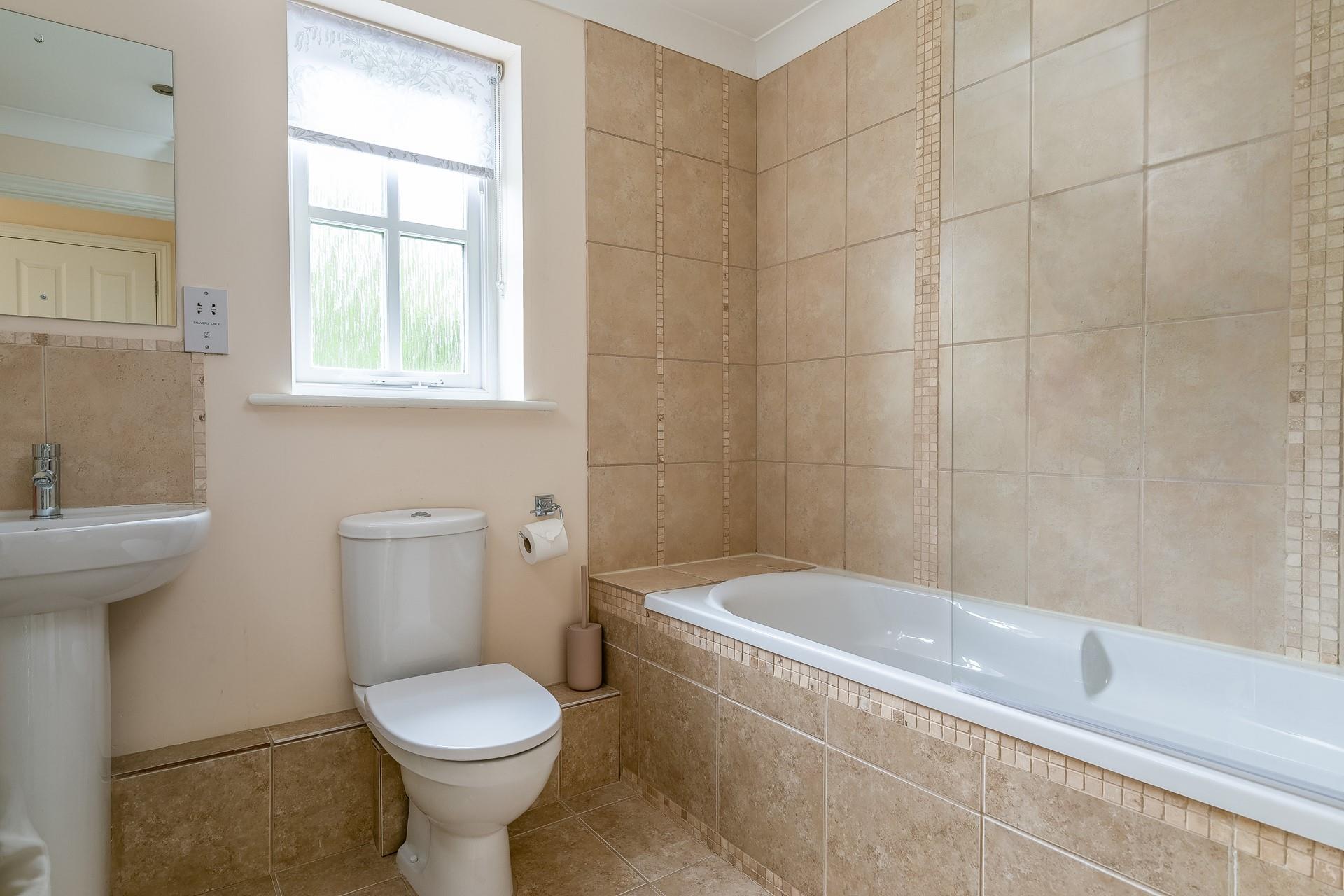 The family bathroom has a shower over bath.