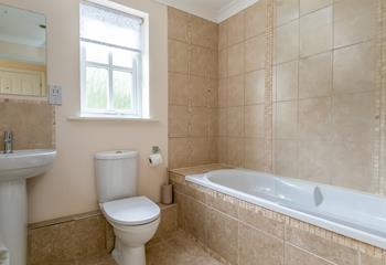 The family bathroom has a shower over bath.