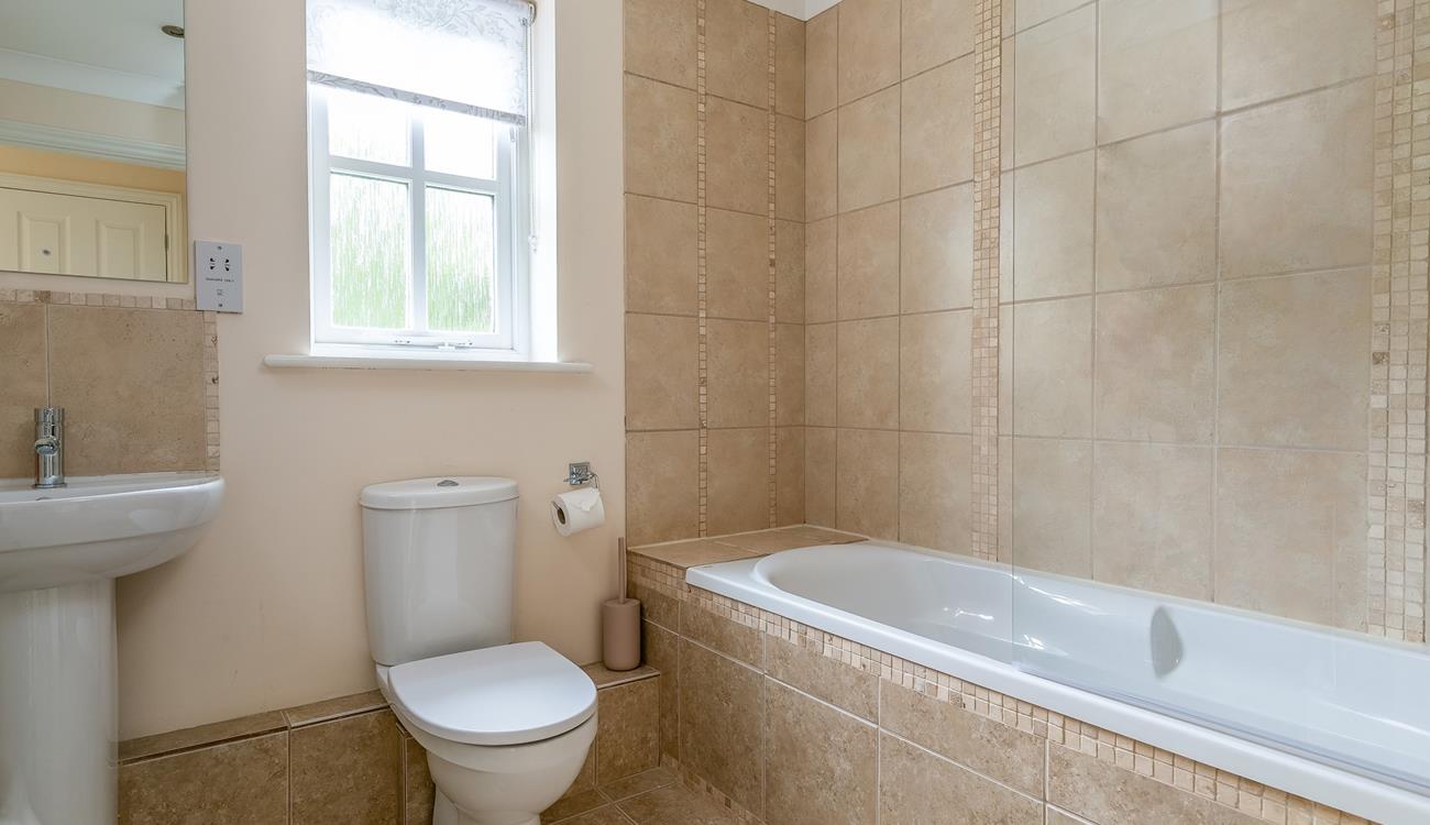 The family bathroom has a shower over bath.