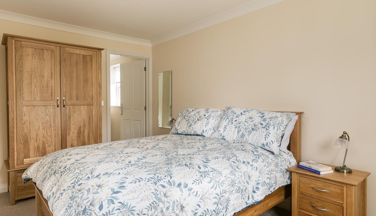 Bedroom 1 is a spacious sanctuary with lots of storage and a comfortable king size bed.