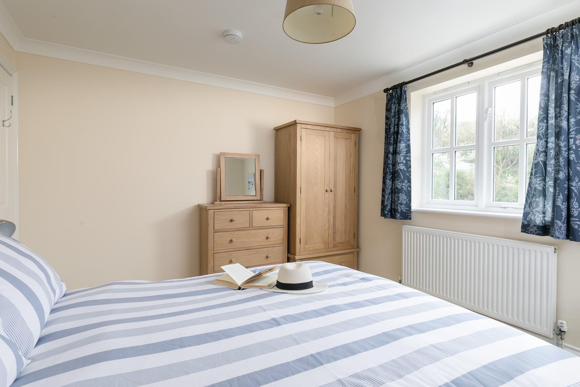 Bedroom 2 is decorated in calming coastal hues.