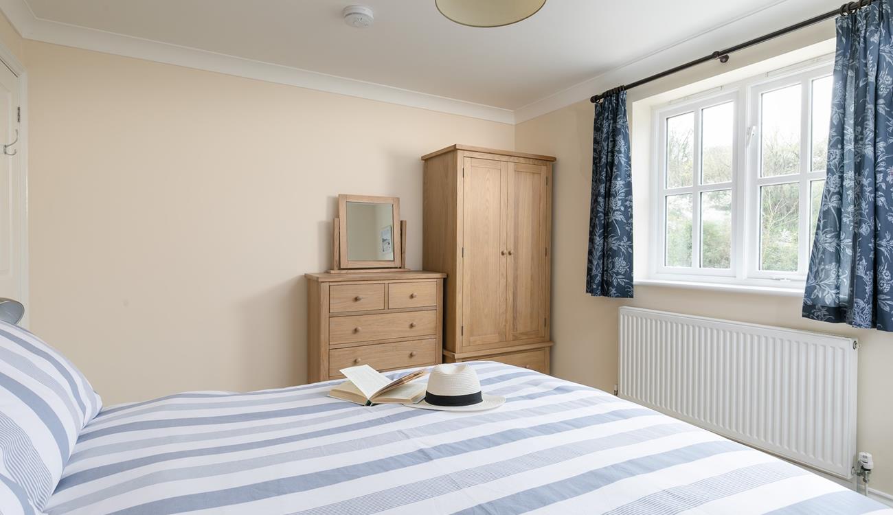 Bedroom 2 is decorated in calming coastal hues.