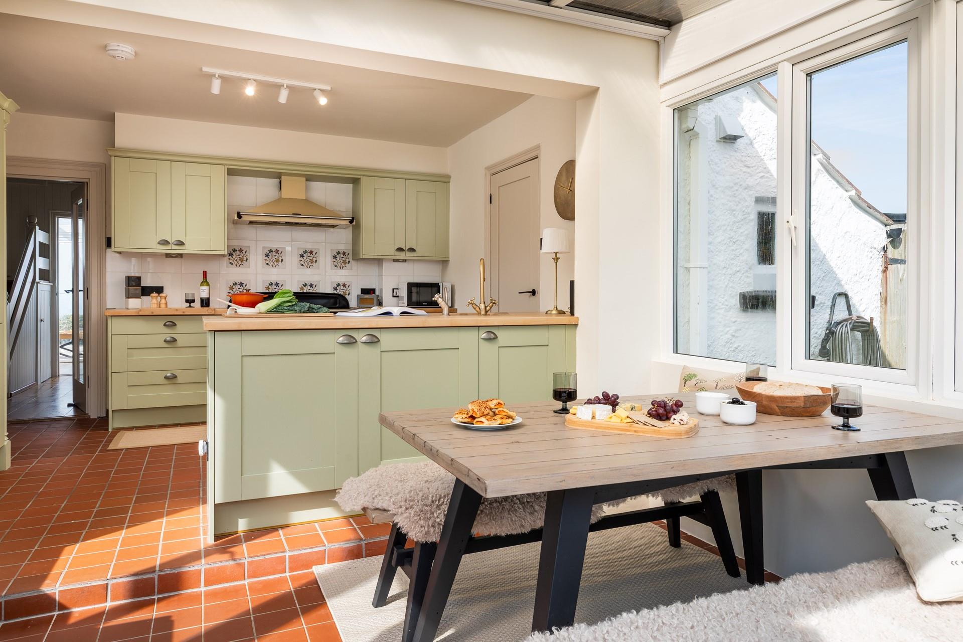 The open plan kitchen and dining room are modern and bright for cooking delicious meals.