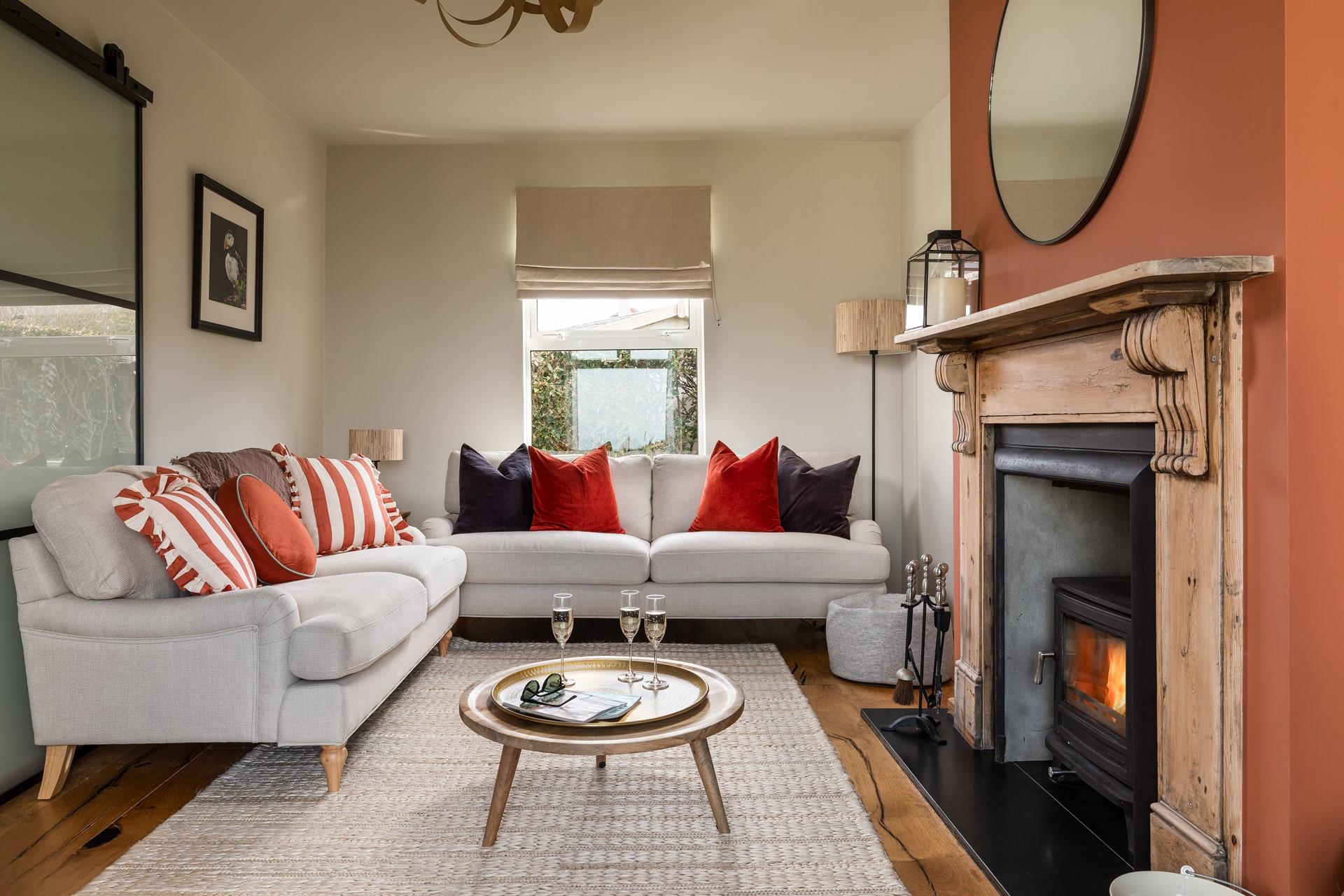 The stylish sitting room is ideal for relaxing in front of the woodburner.
