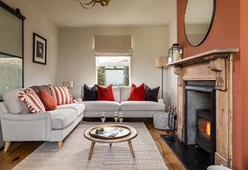 The stylish sitting room is ideal for relaxing in front of the woodburner.