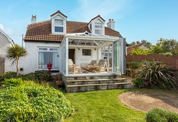 Enjoy al fresco evenings in the garden watching the ocean blues.