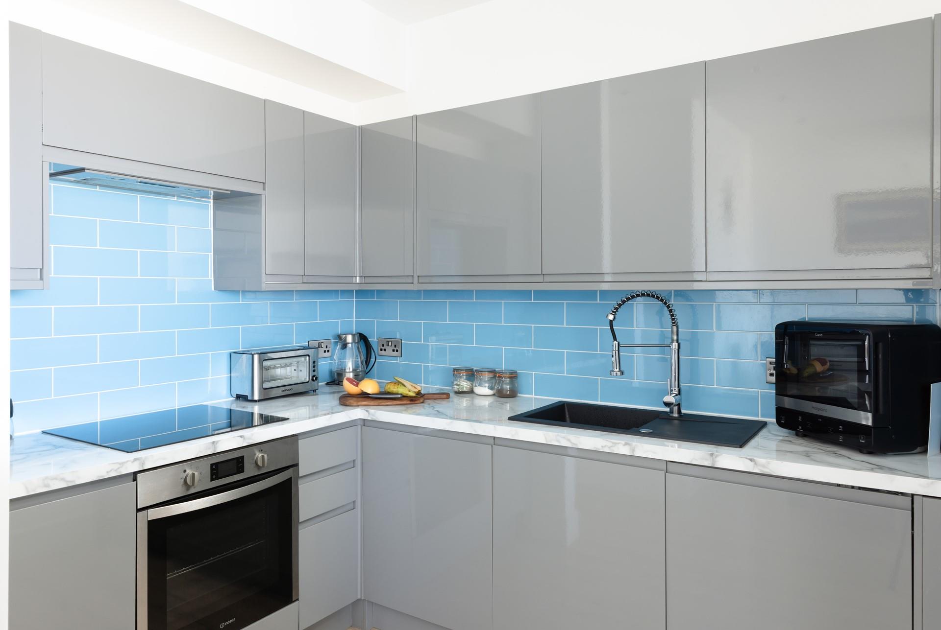 The kitchen is sleek and compact.