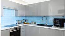 The kitchen is sleek and compact.
