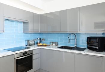 The kitchen is sleek and compact.