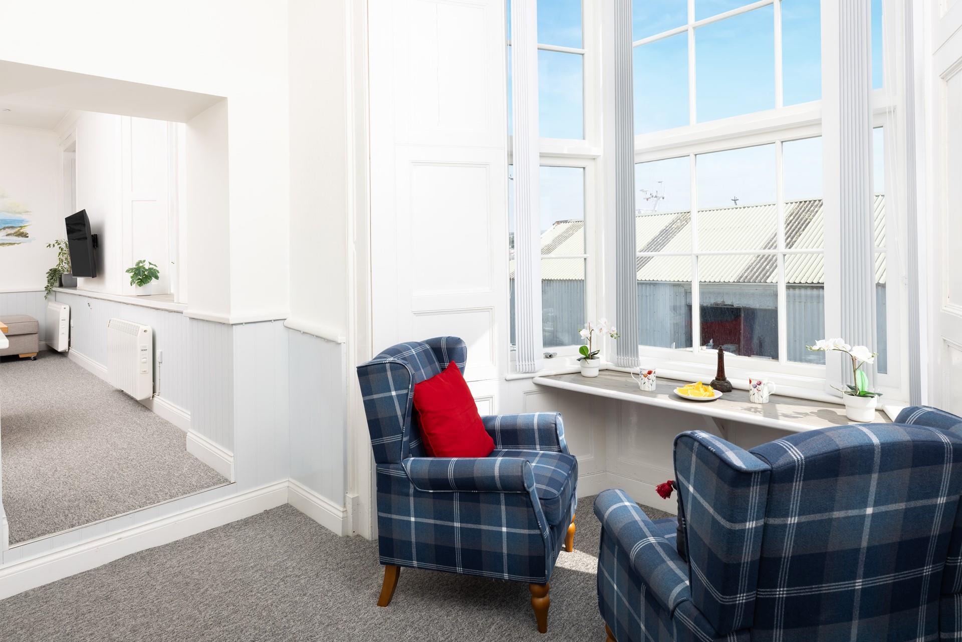 The bay window is a lovely spot for curling up with a good book.