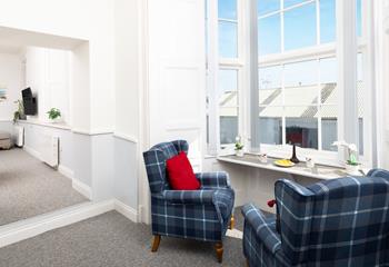 The bay window is a lovely spot for curling up with a good book.