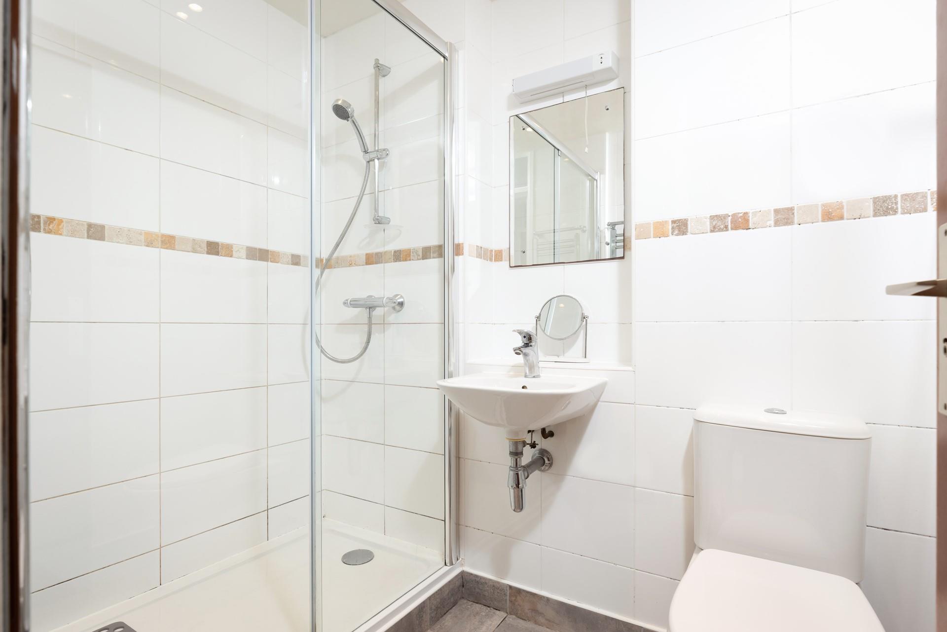 The bathroom boasts a spacious walk-in shower.