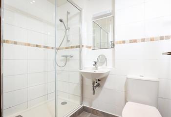 The bathroom boasts a spacious walk-in shower.