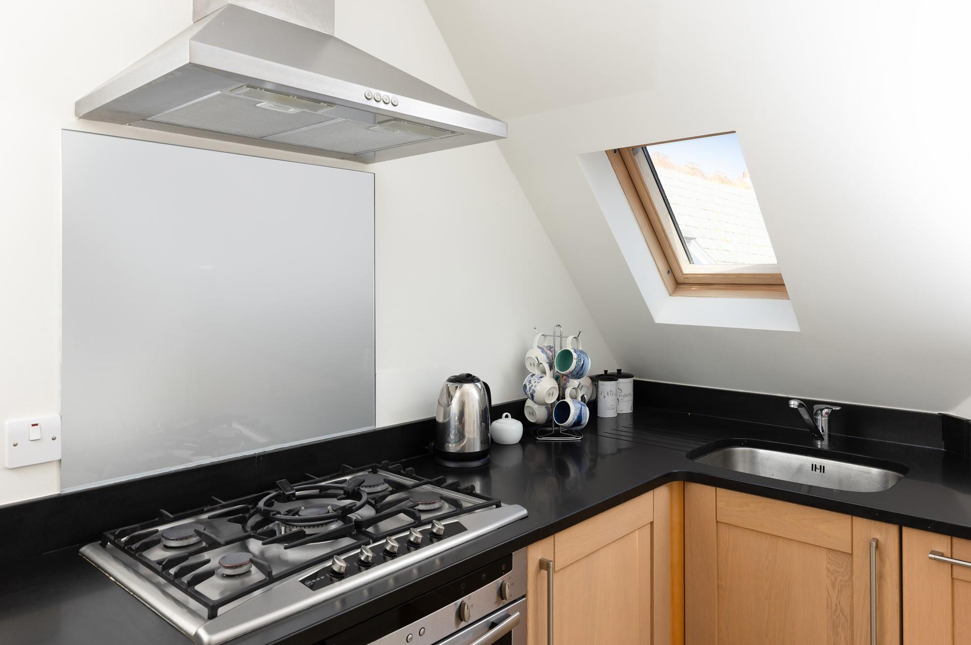 The compact kitchen is well-equipped with all you need.