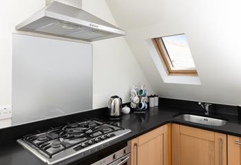 The compact kitchen is well-equipped with all you need.