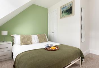 Calming green hues create a relaxing space in bedroom 3.