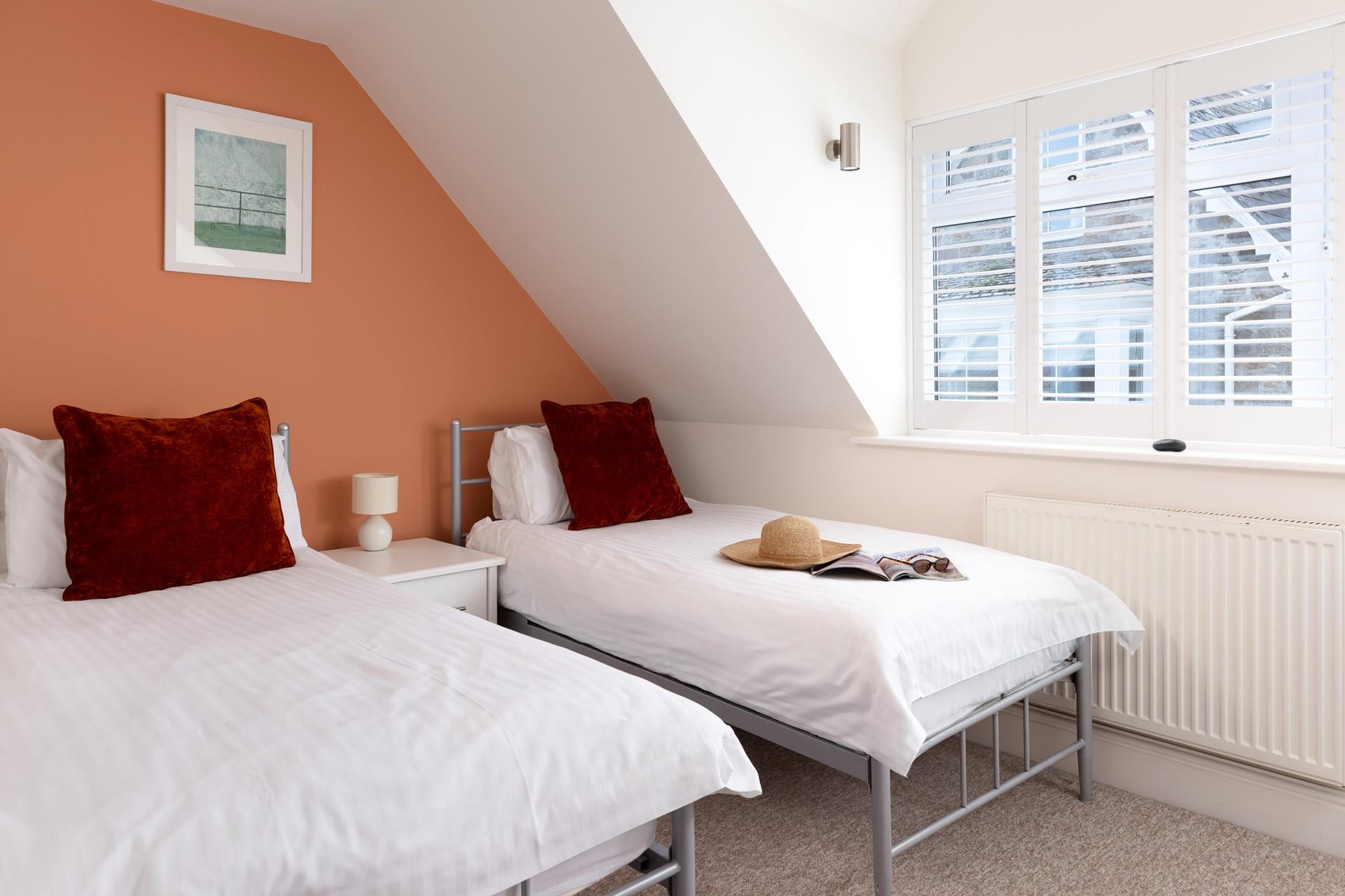 Bedroom 2 has twin beds, suitable for both adults and children.